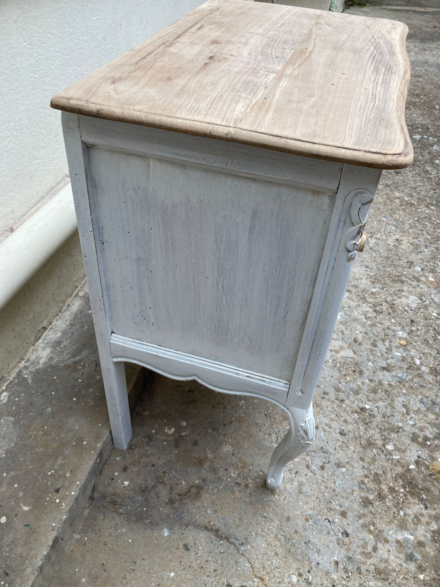 Adorable small chest of drawers or weathered white console.