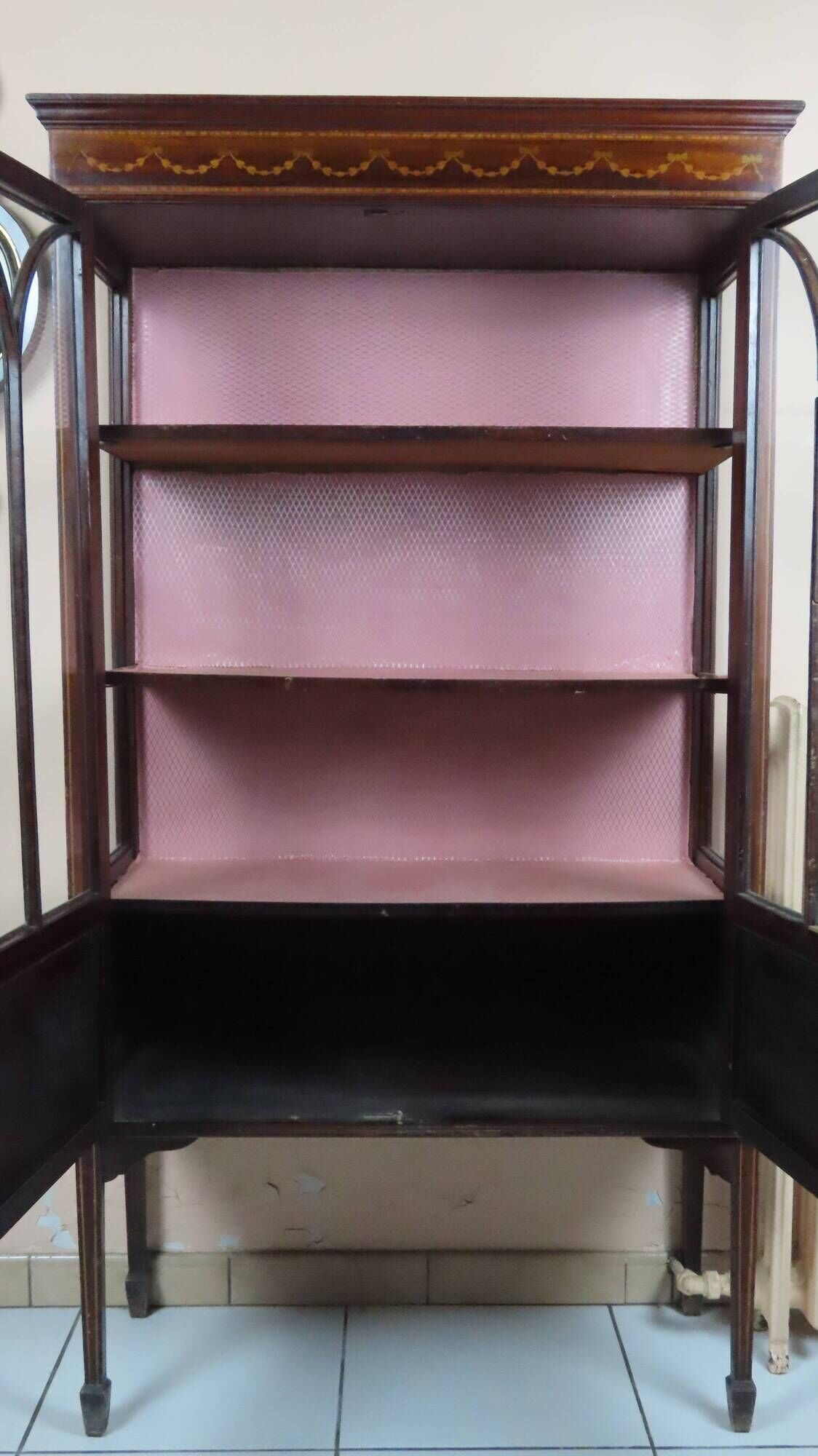 Antique English display cabinet. Marquetry with floral patterns and ribbons.