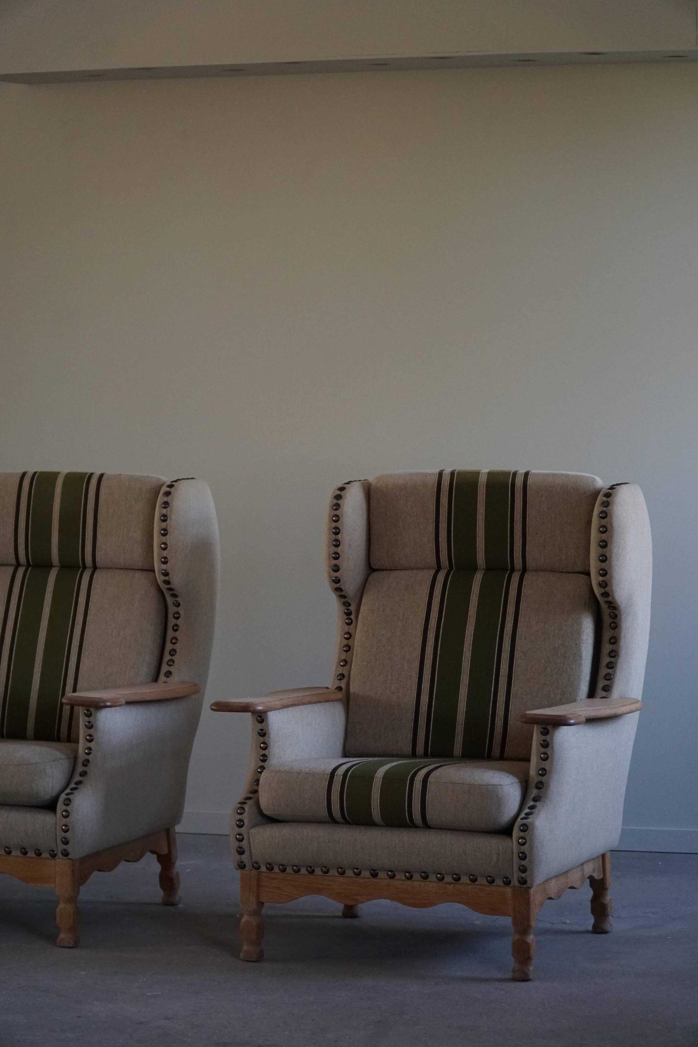 Pair of high-back lounge chairs in modern Danish style in the manner of Henning Kjærnulf, 1960s.