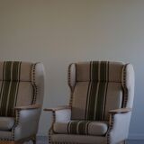 Pair of high-back lounge chairs in modern Danish style in the manner of Henning Kjærnulf, 1960s.