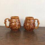 Set of 2 vintage caramel-colored slip mugs with flower pattern