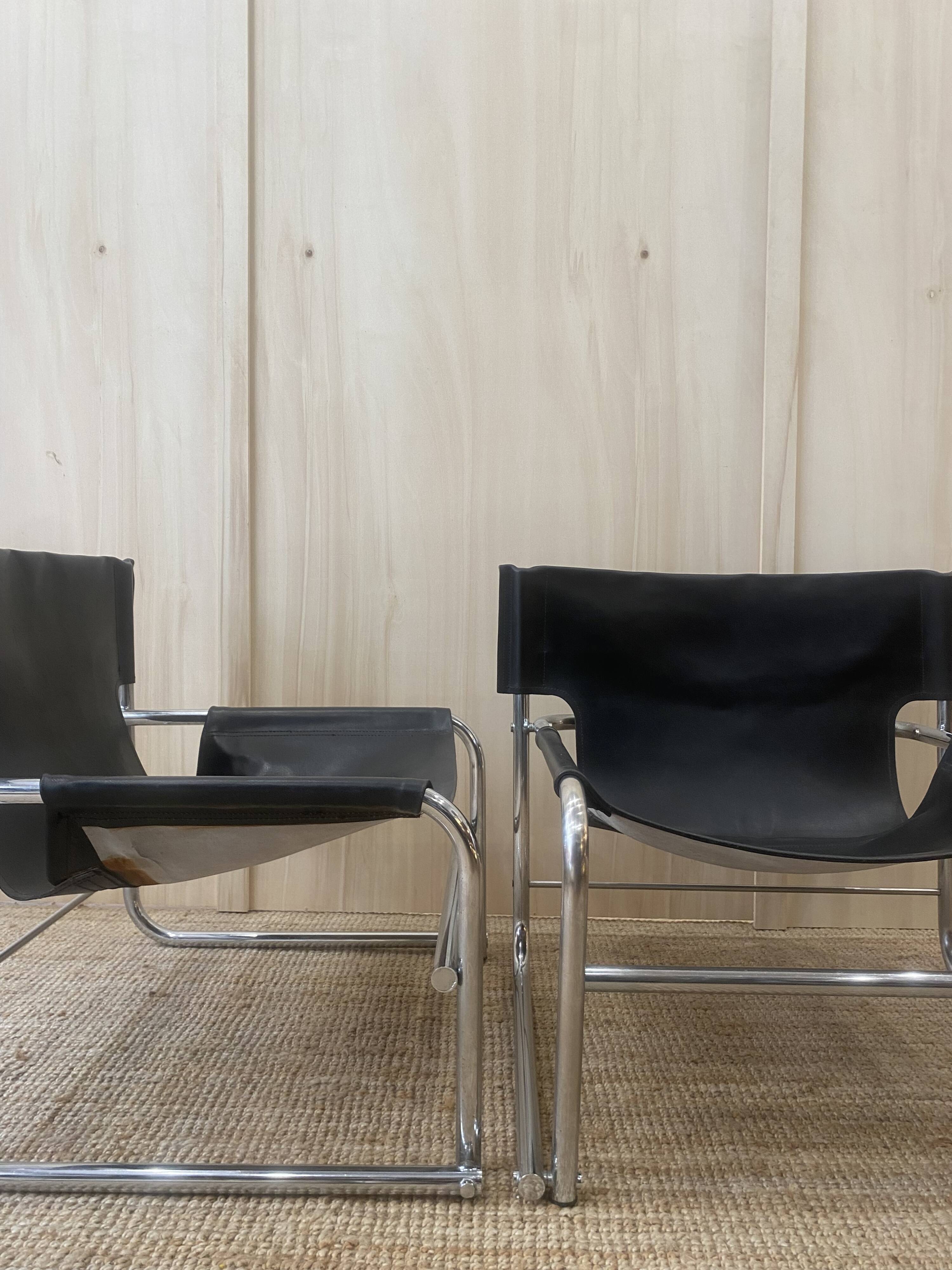 Black leather armchairs with a metal frame by Rodney Kinsman.