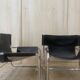 Black leather armchairs with a metal frame by Rodney Kinsman.
