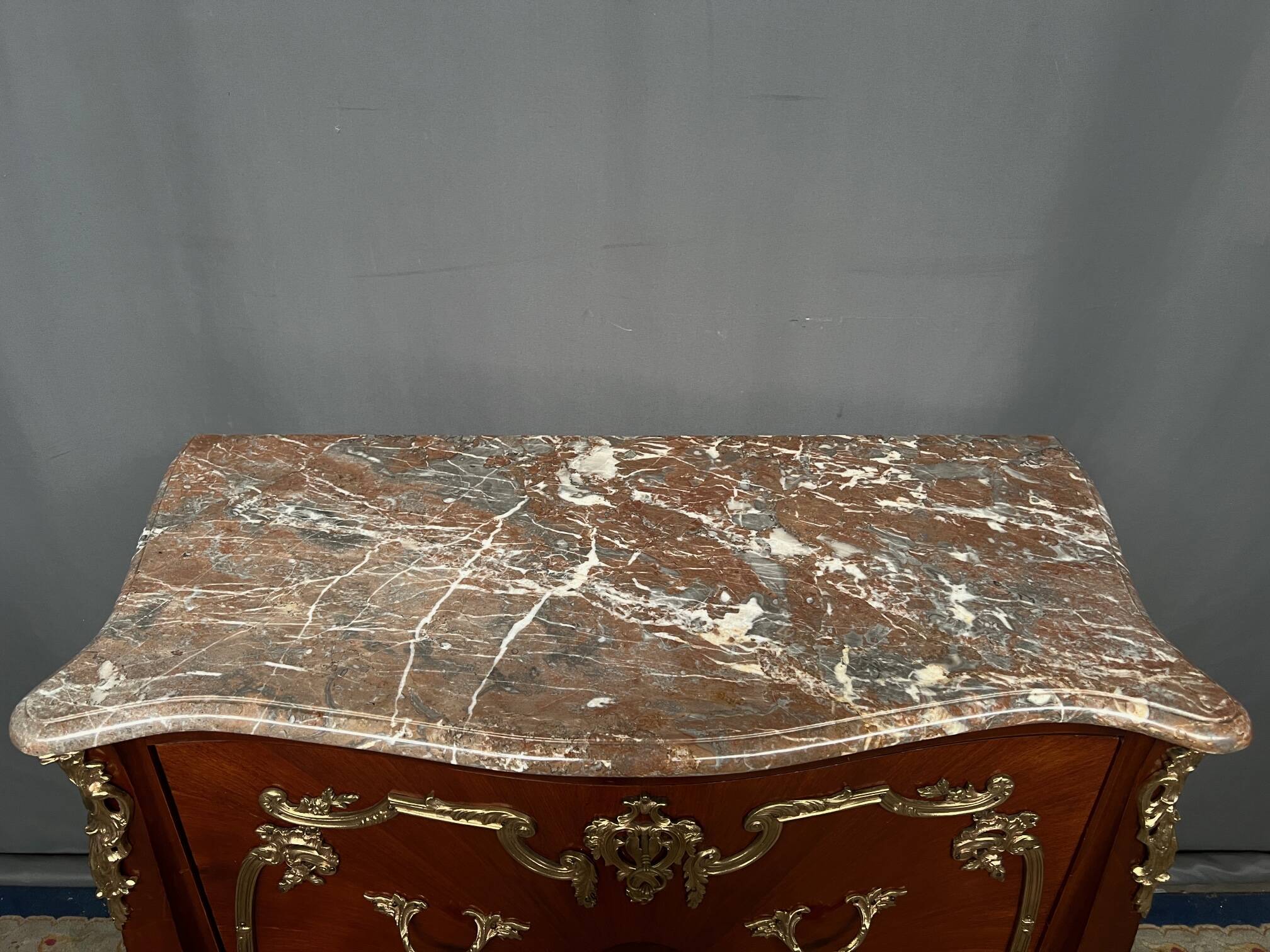 Louis XV style commode. Marquetry, gilded bronze decoration.