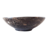 Empty pocket in fossilized black marble