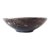 Empty pocket in fossilized black marble