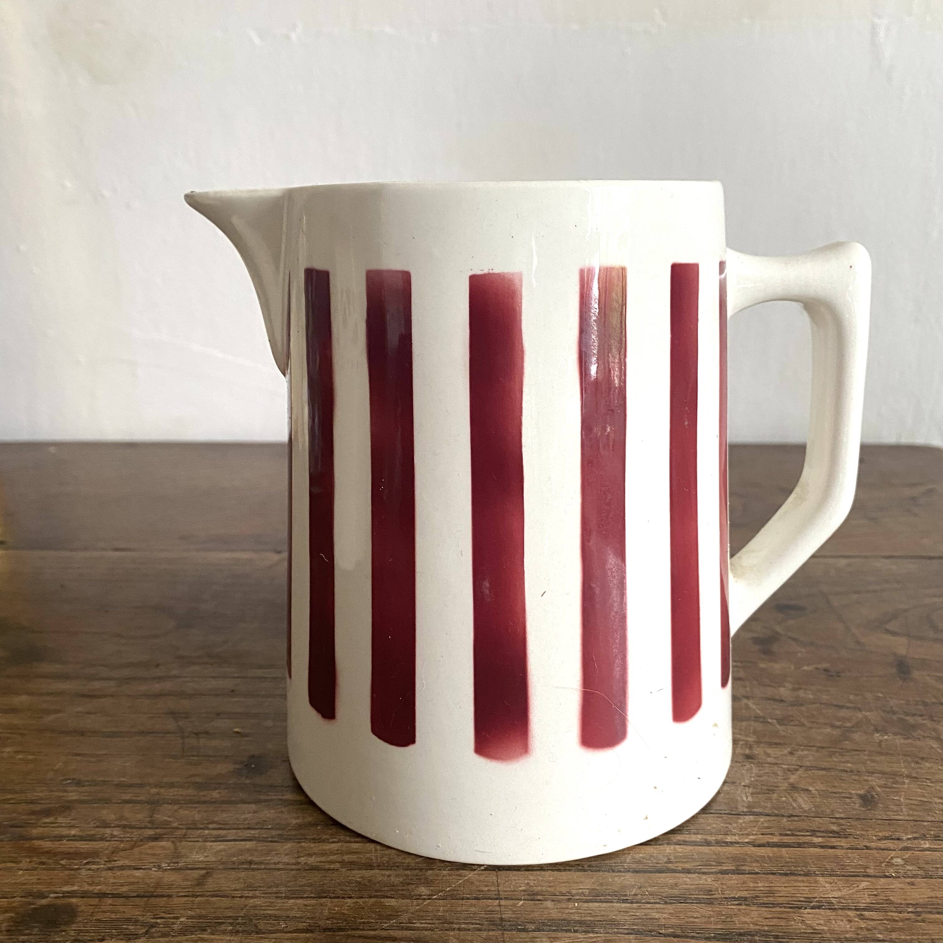 Antique earthenware pitcher with burgundy stripes