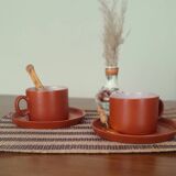 terracotta cups with saucers