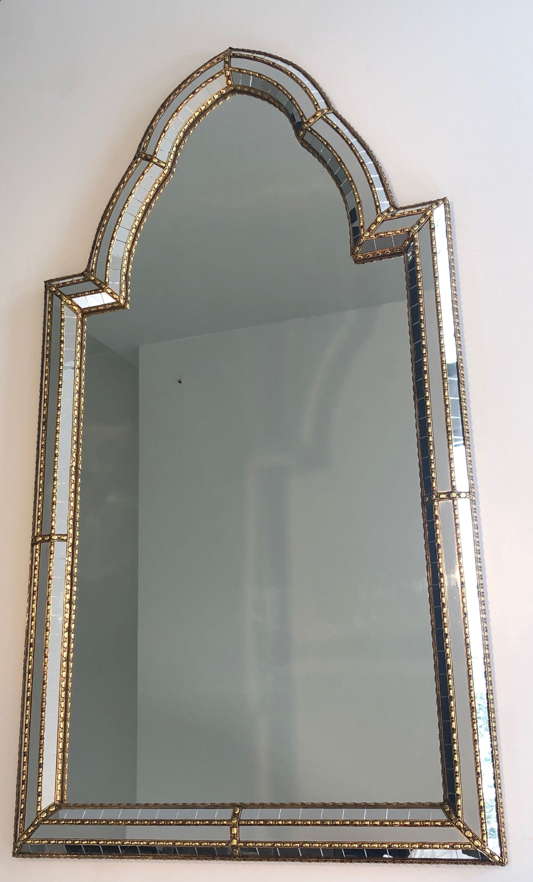 Mirror consisting of multi-faceted mirrors and brass garlands, French work, around 1970