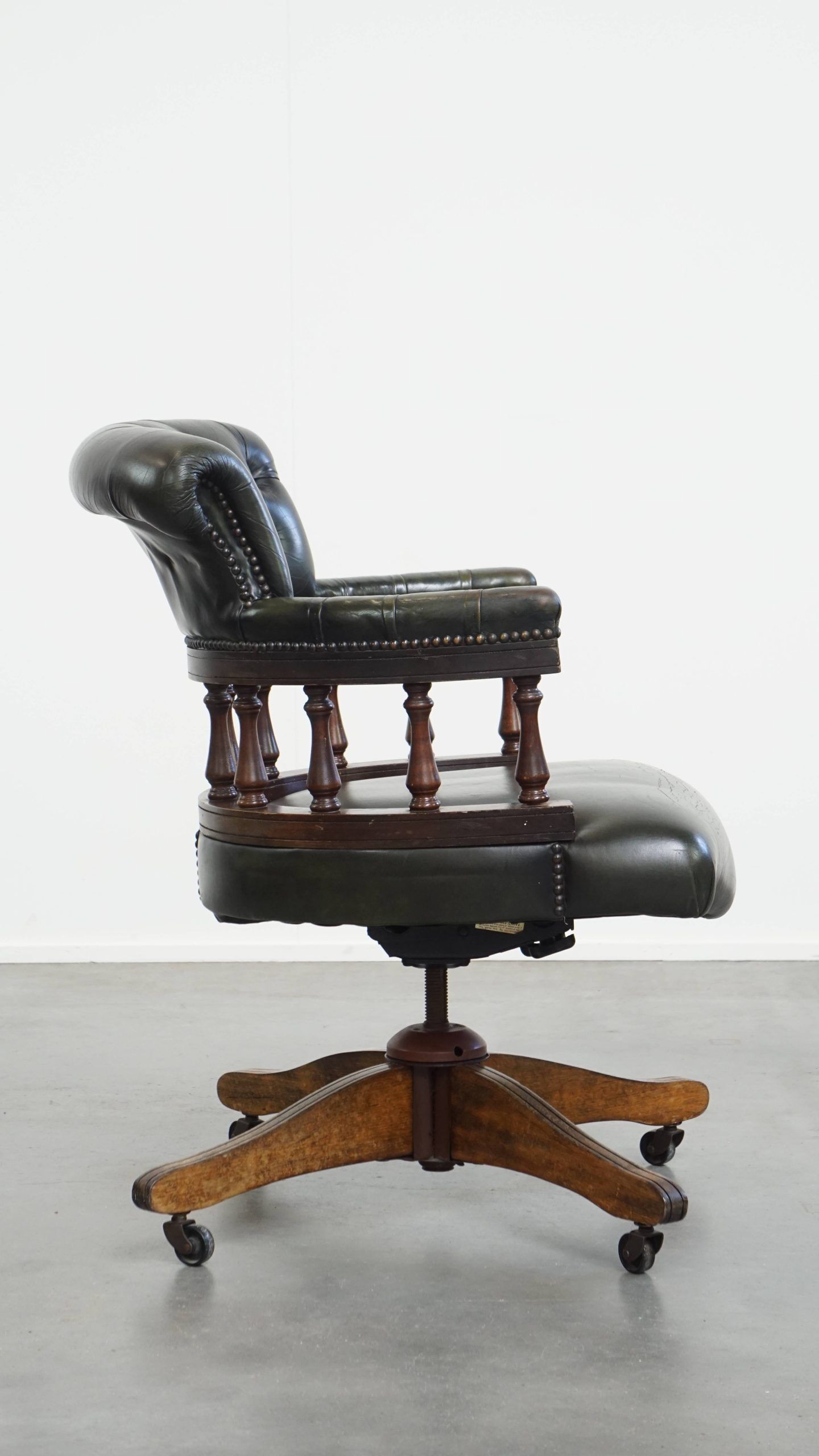 Adjustable green leather and wood Chesterfield office chair with swivel