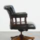 Adjustable green leather and wood Chesterfield office chair with swivel