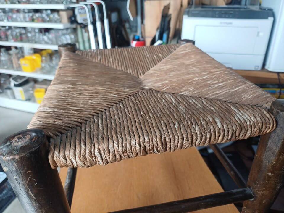 Small rustic vintage stool in wood and straw.