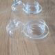 2 transparent glass butter dishes with their matching cloches.