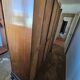 Large English-style wardrobe with a curved front and three doors.