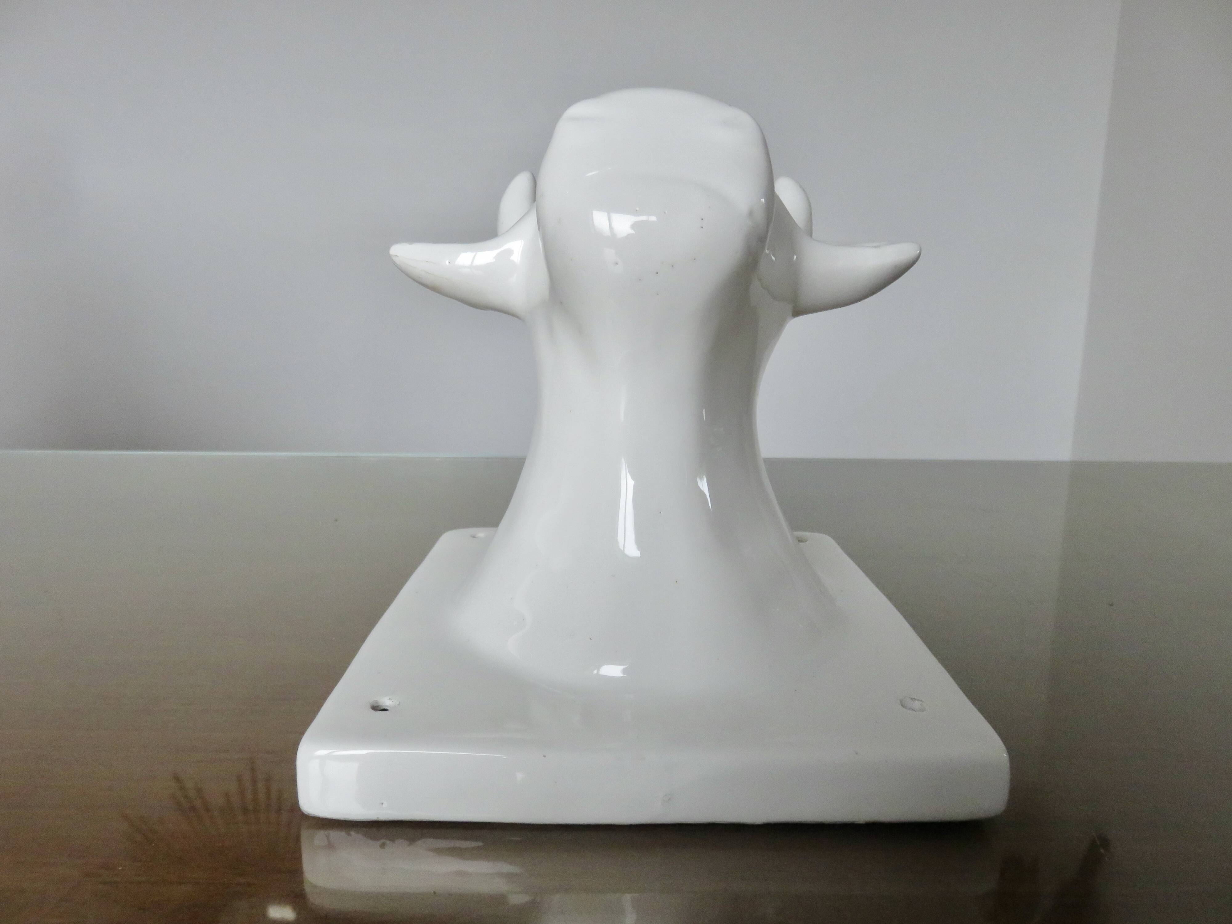 Stylized cow head in white ceramic, wall decoration from the 80s