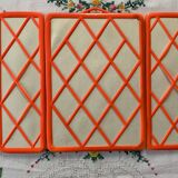 Orange plastic triptych mirror