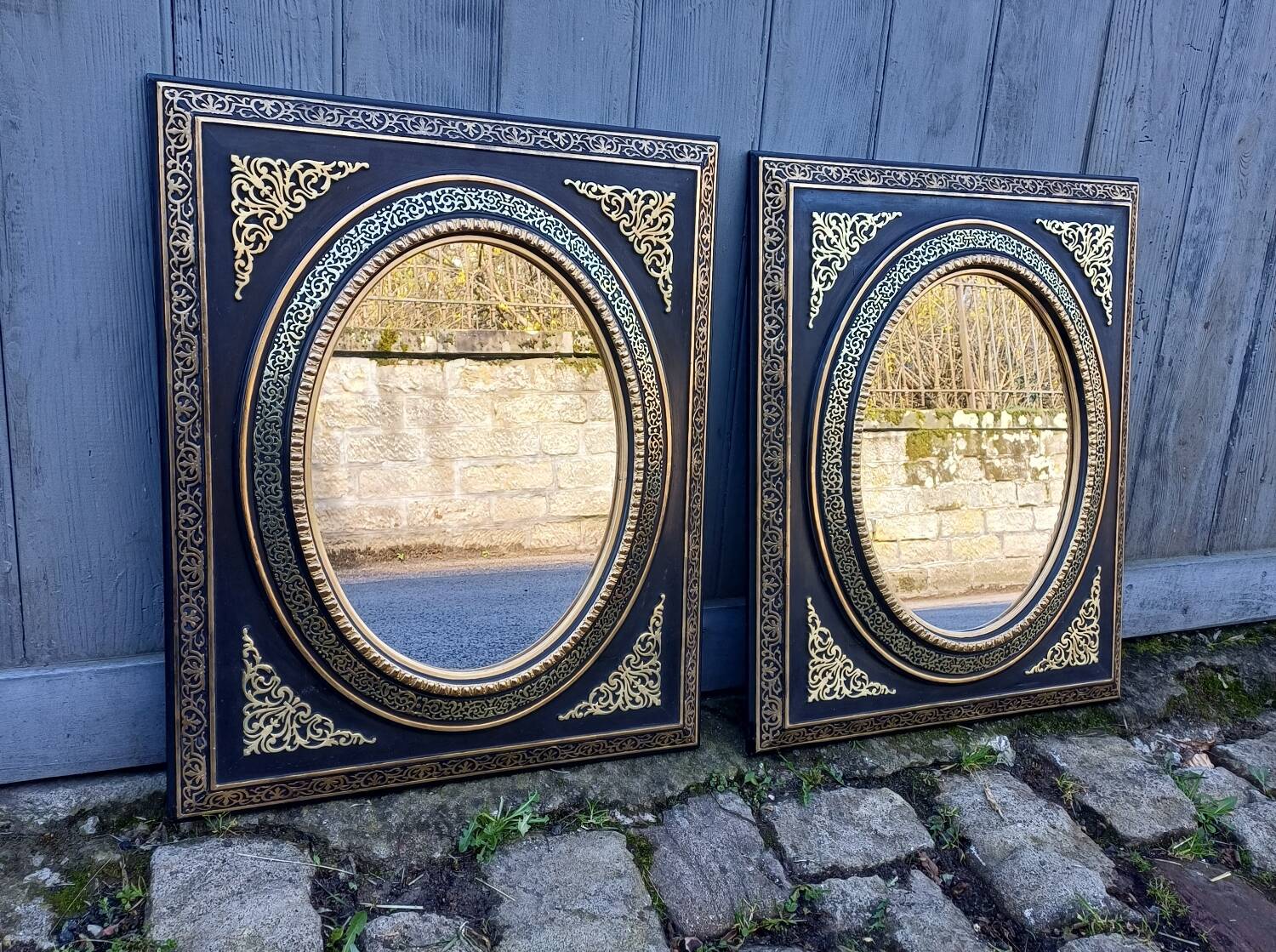 Pair of antique mirrors from the Napoléon III period, black and gilded.