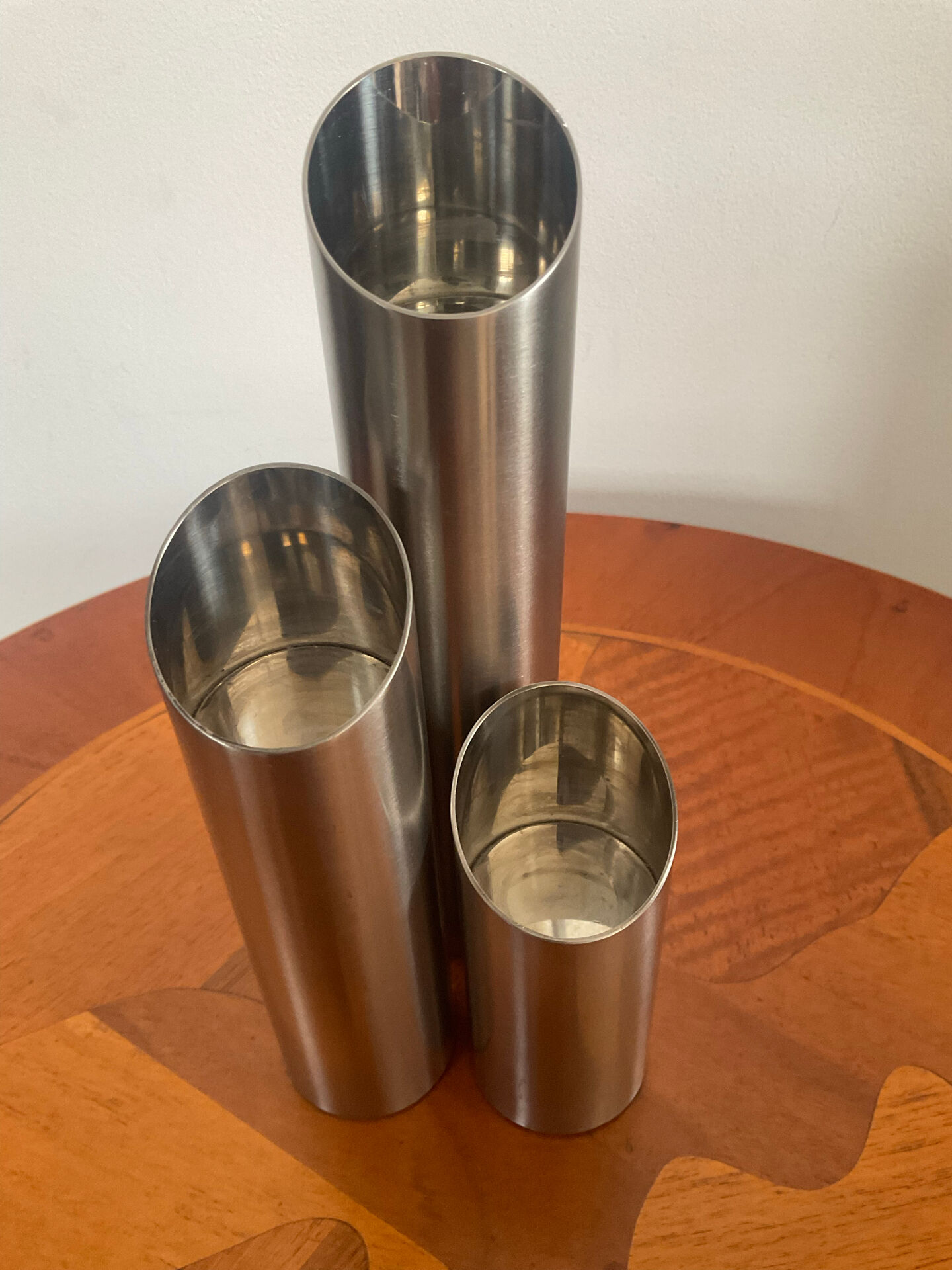 Vintage trio of brushed stainless steel candle holders