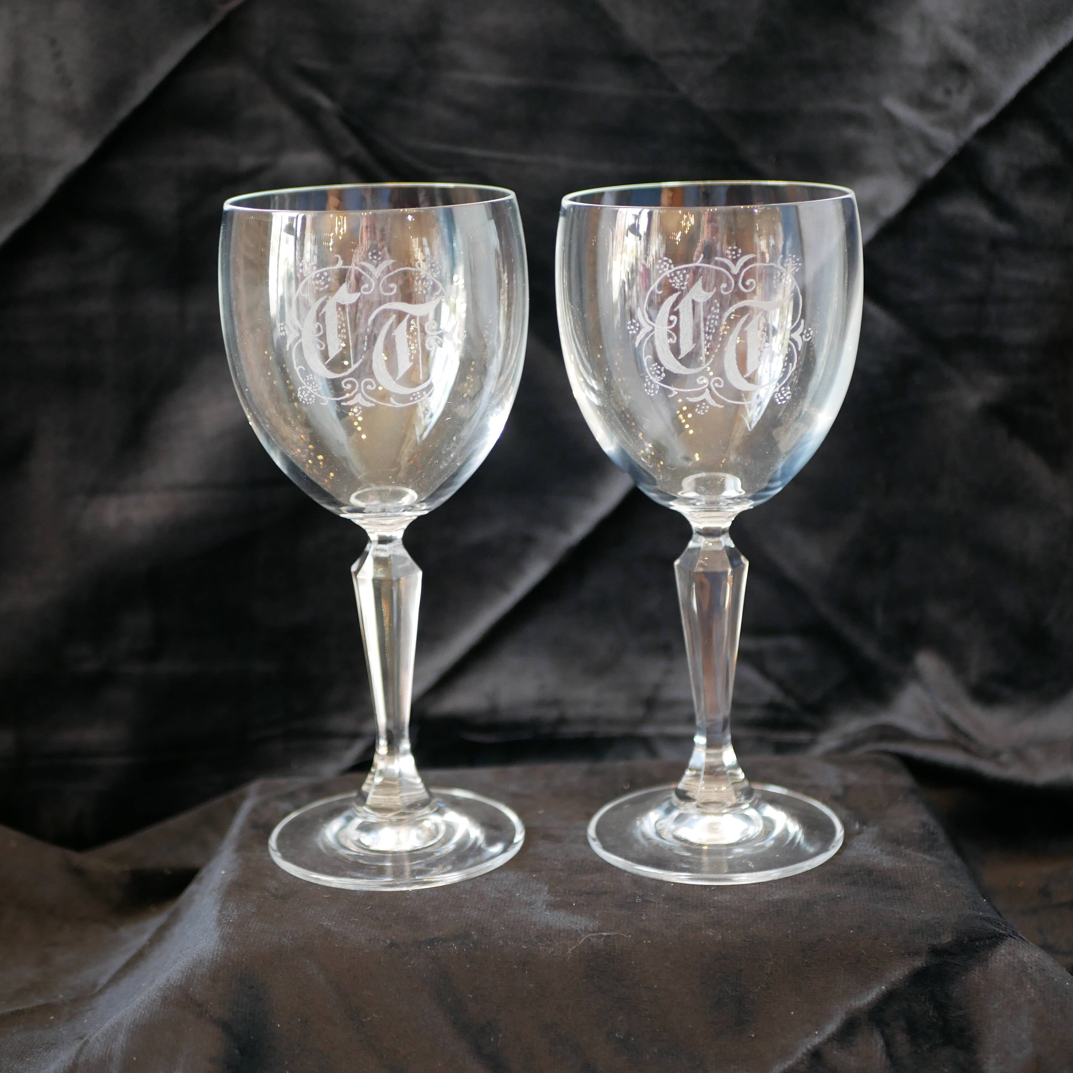 A pair of engraved crystal wine glasses