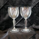 A pair of engraved crystal wine glasses