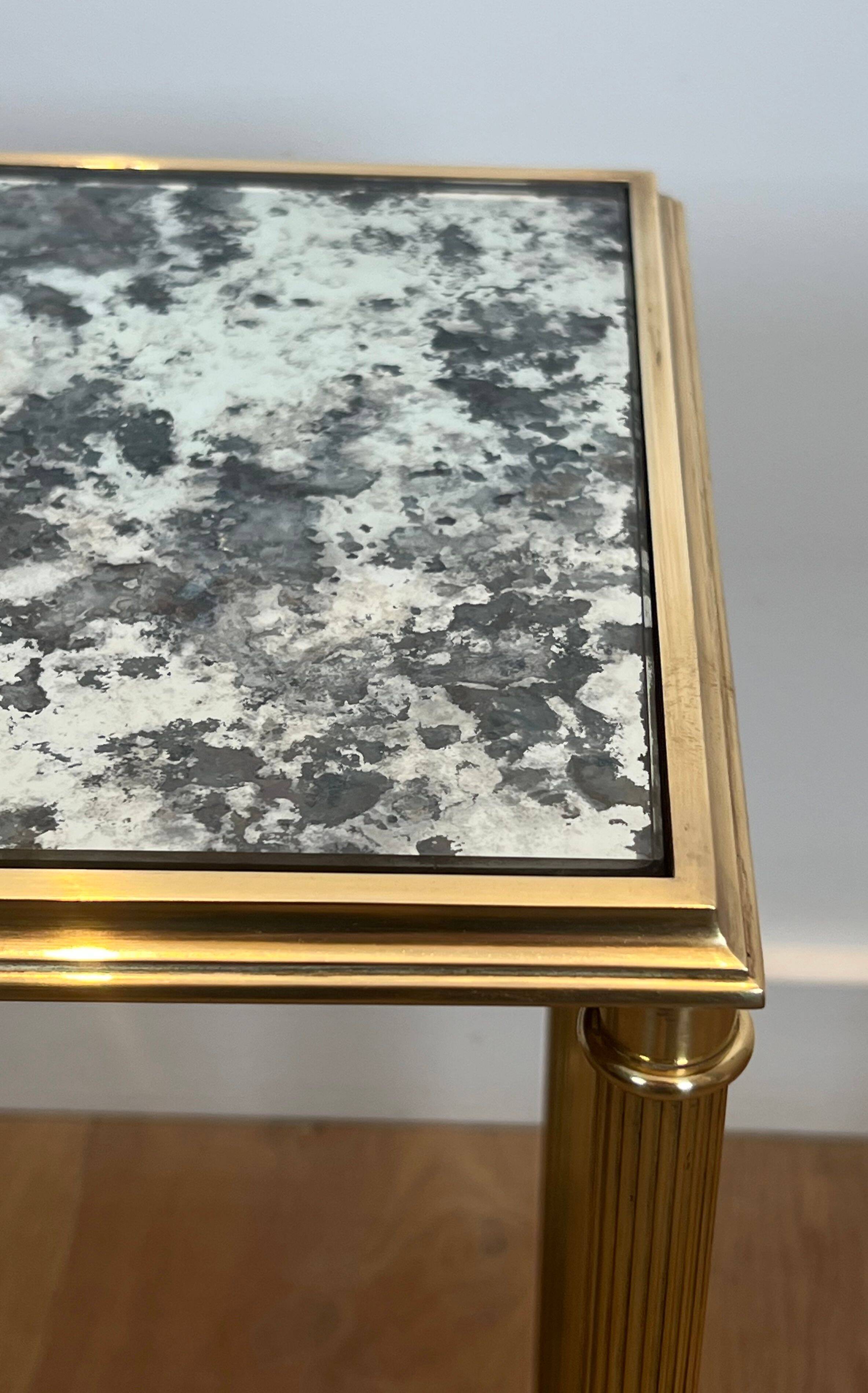 Pair of brass and antique mirror side tables from the Baguès house.