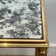 Pair of brass and antique mirror side tables from the Baguès house.