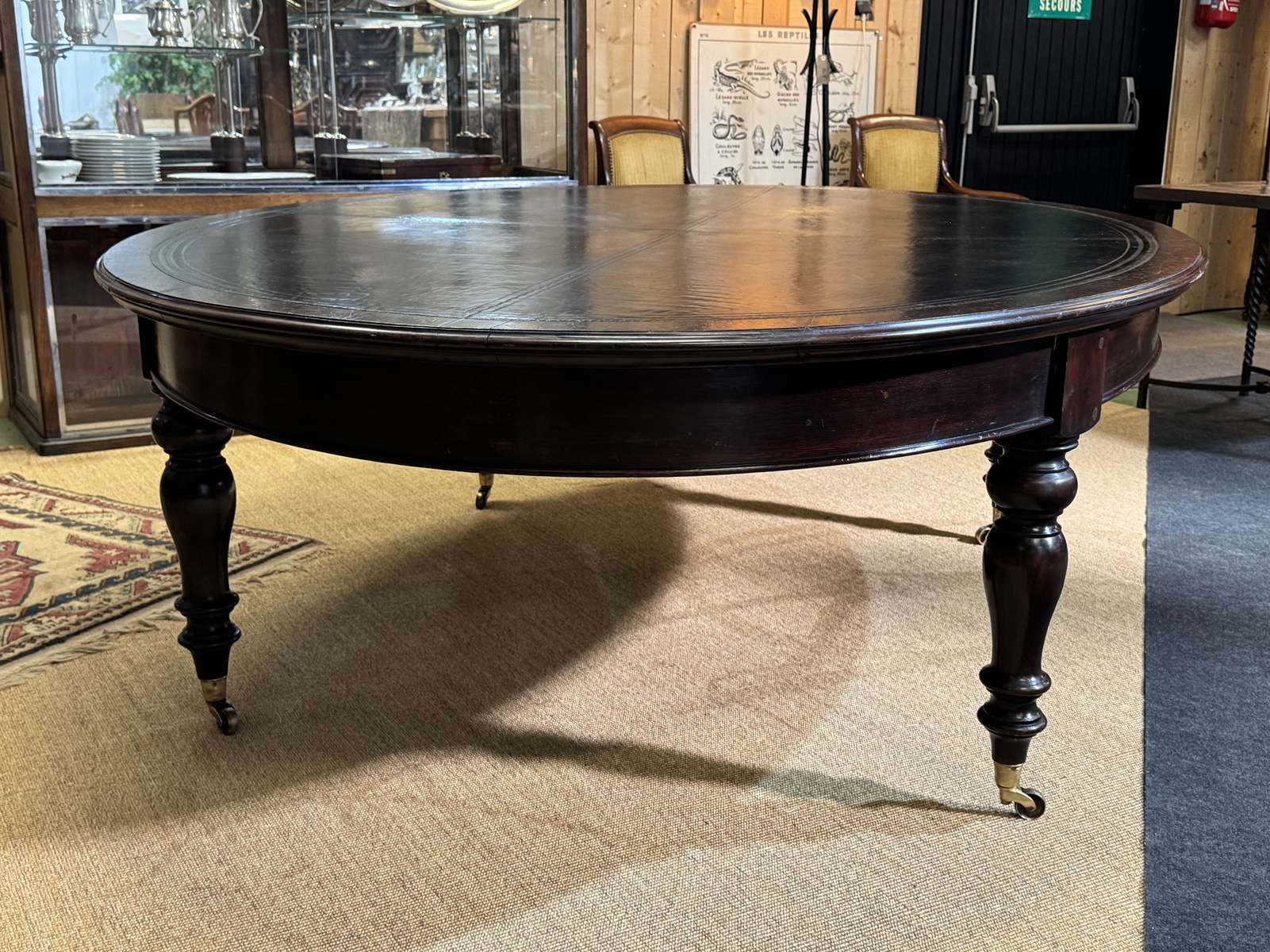 Large English library table in dark walnut with a leather top.