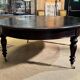 Large English library table in dark walnut with a leather top.