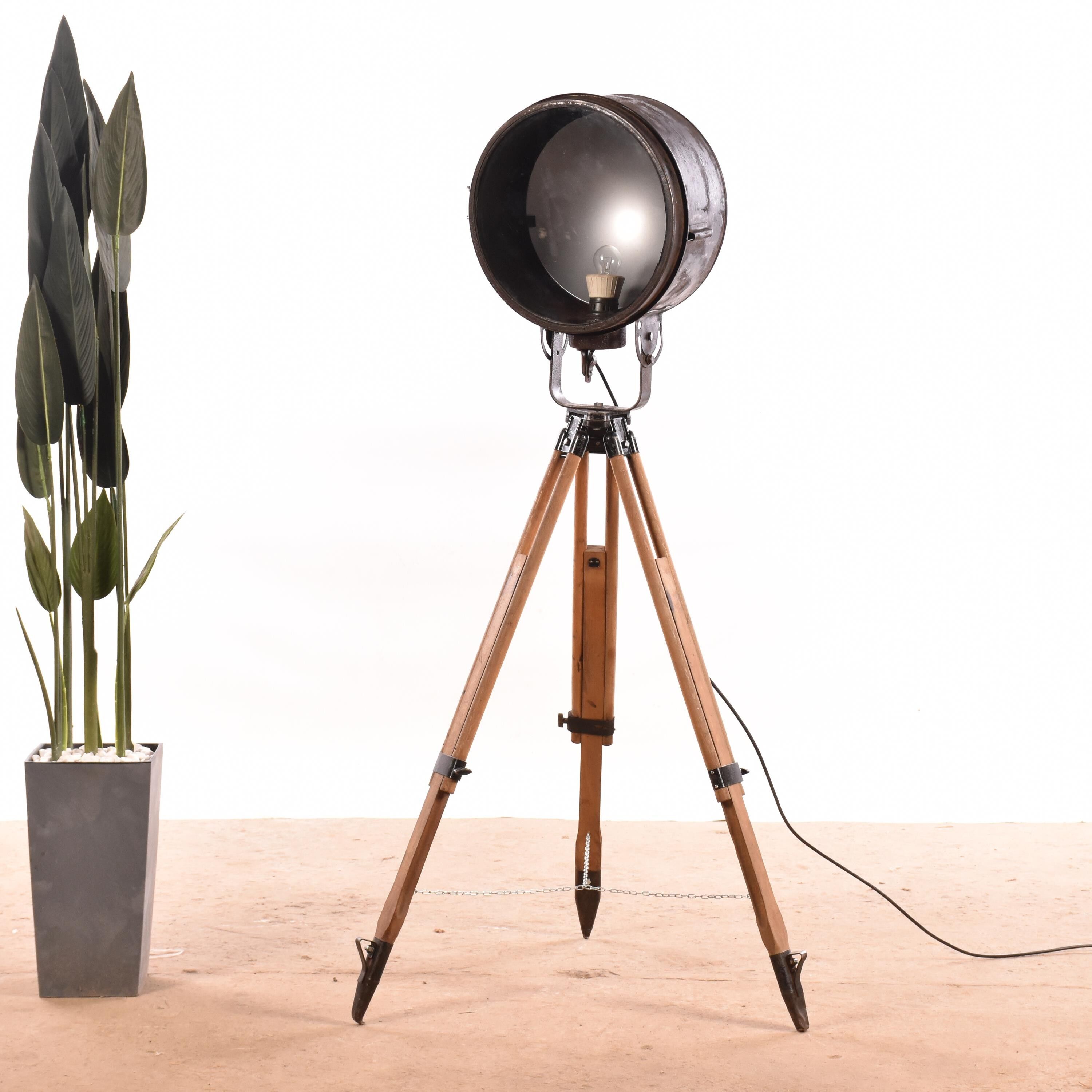 Old industrial spot on wooden tripod floor lamp