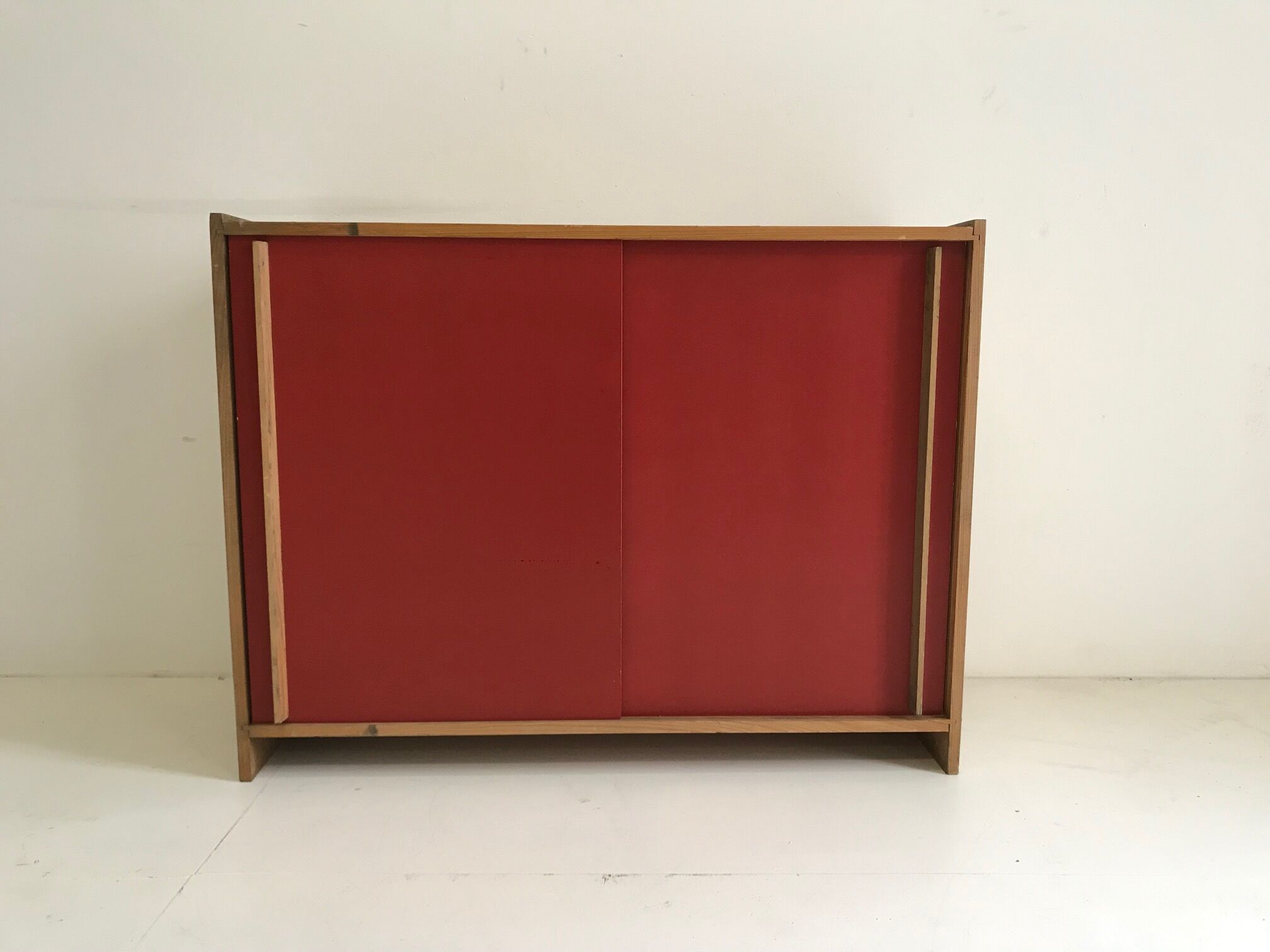 Vintage furniture with red sliding doors
