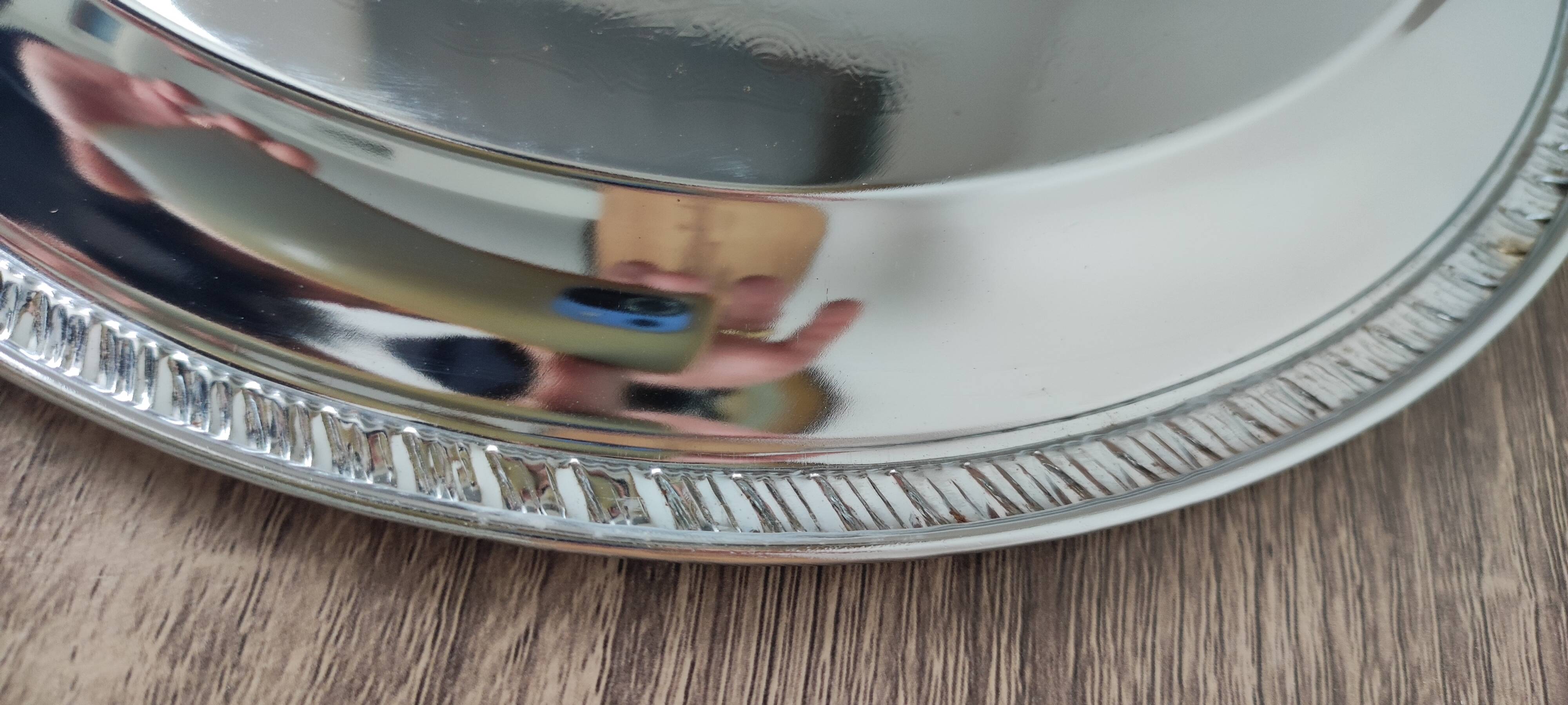 Silver-plated metal dish with a 1980s pattern.