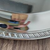 Silver-plated metal dish with a 1980s pattern.