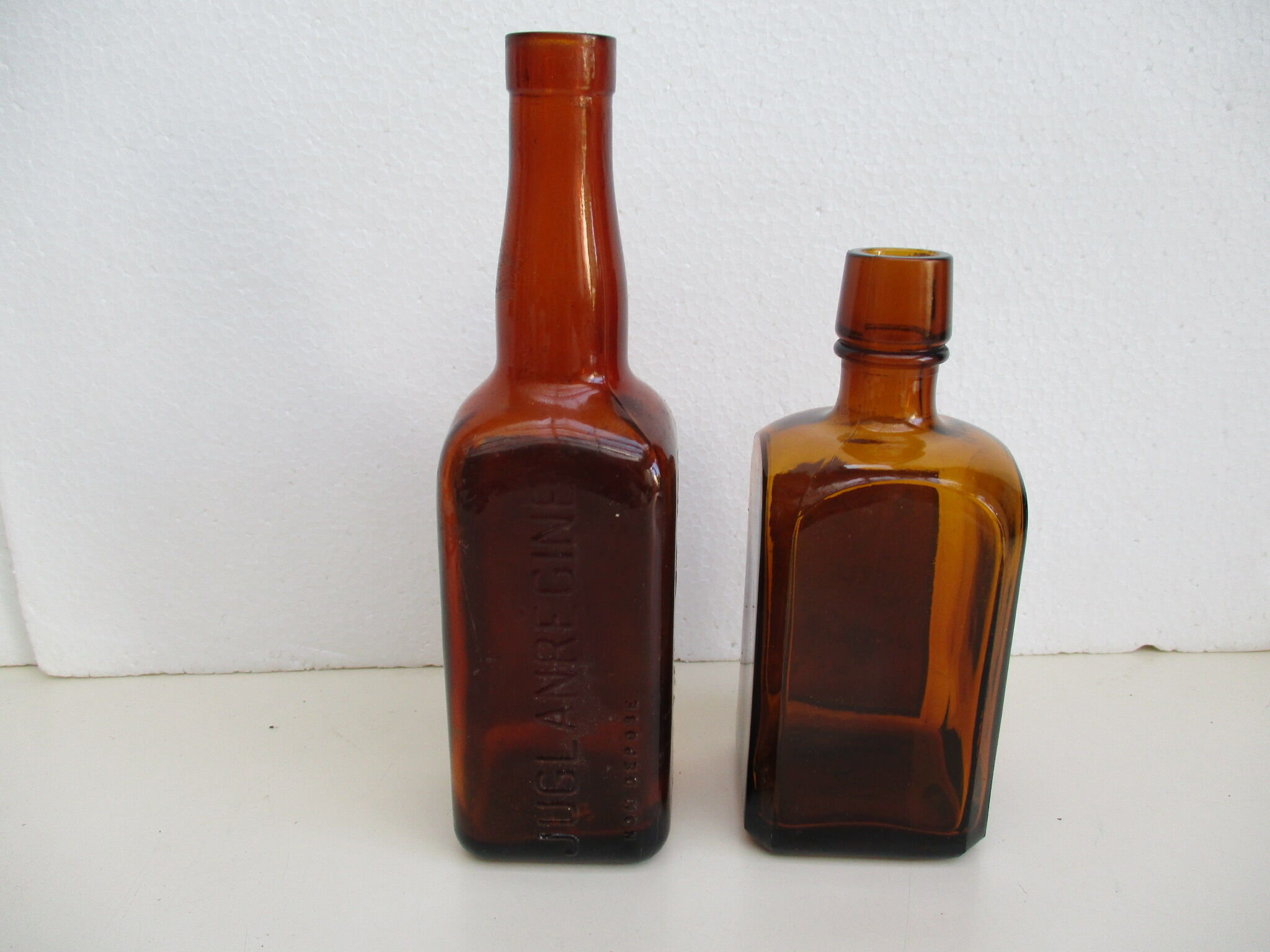 2 amber glass bottles with their old labels