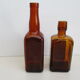 2 amber glass bottles with their old labels