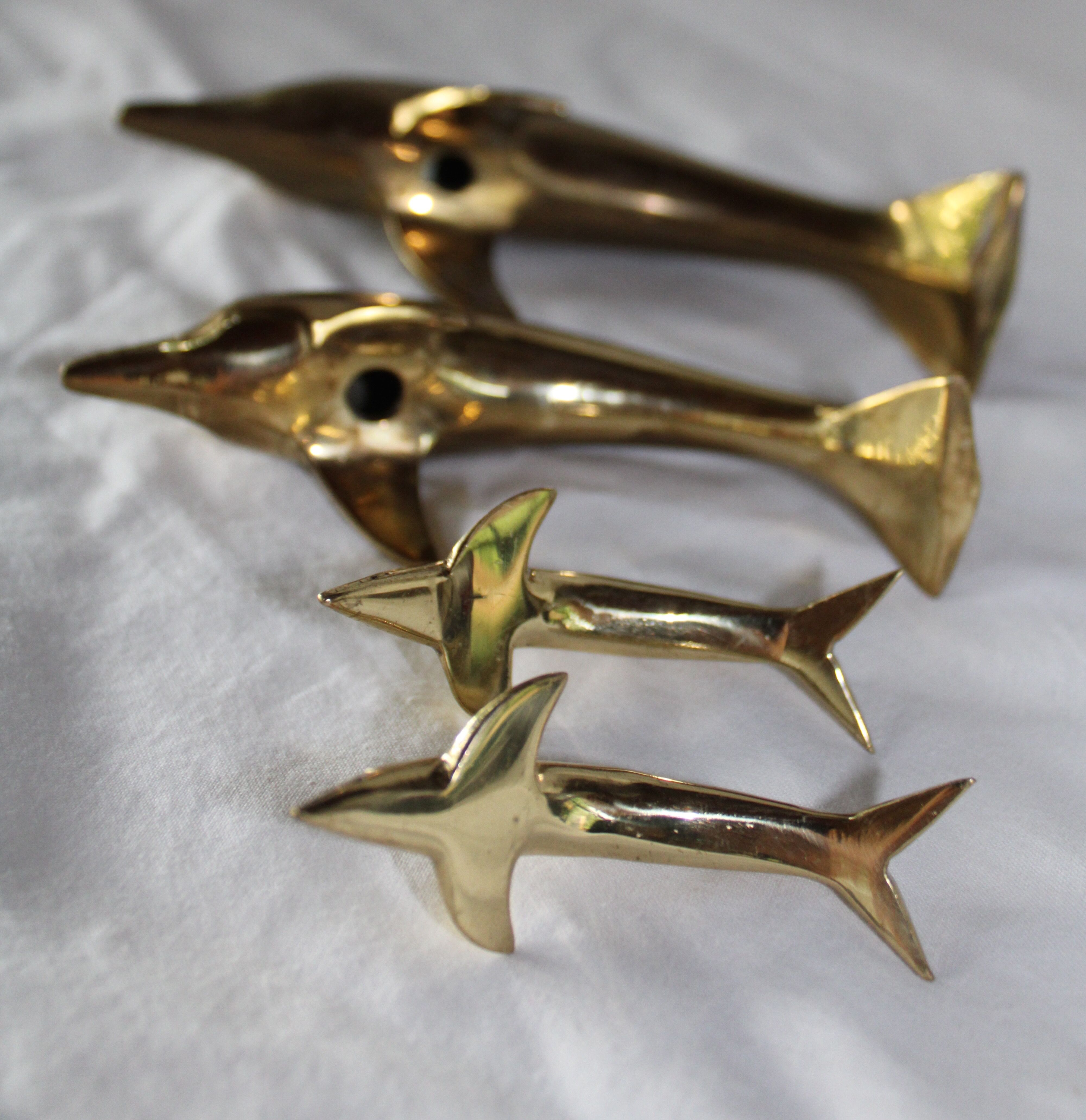 Family of dolphins in vintage brass