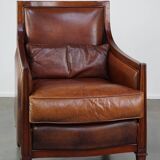 Comfortable Art Deco design armchair in cognac-colored sheepskin combined with wood
