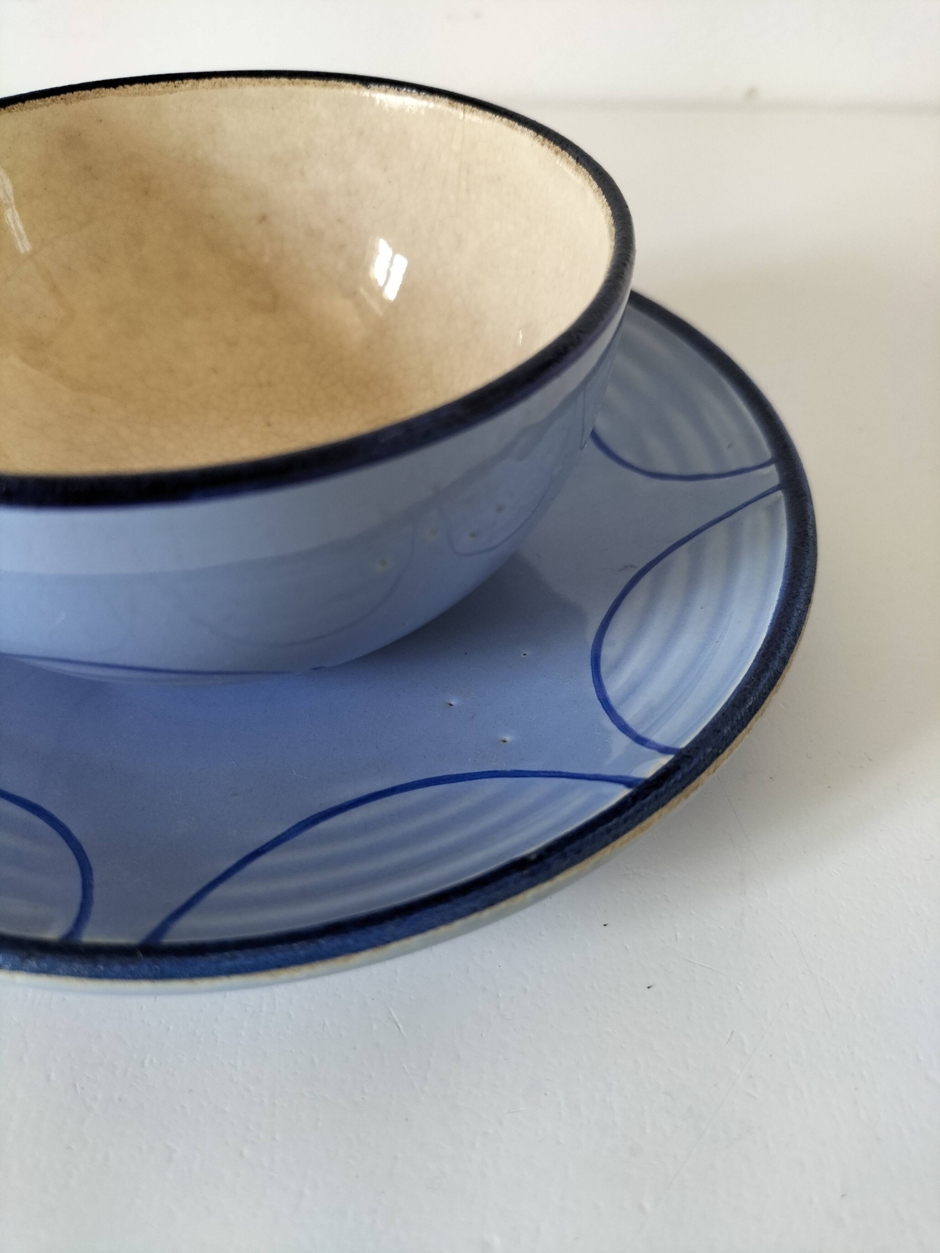 A pair of glazed ceramic cups and saucers from the 60s-70s.
