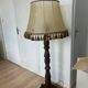 Large vintage wooden floor lamp with parchment shade and pendants.