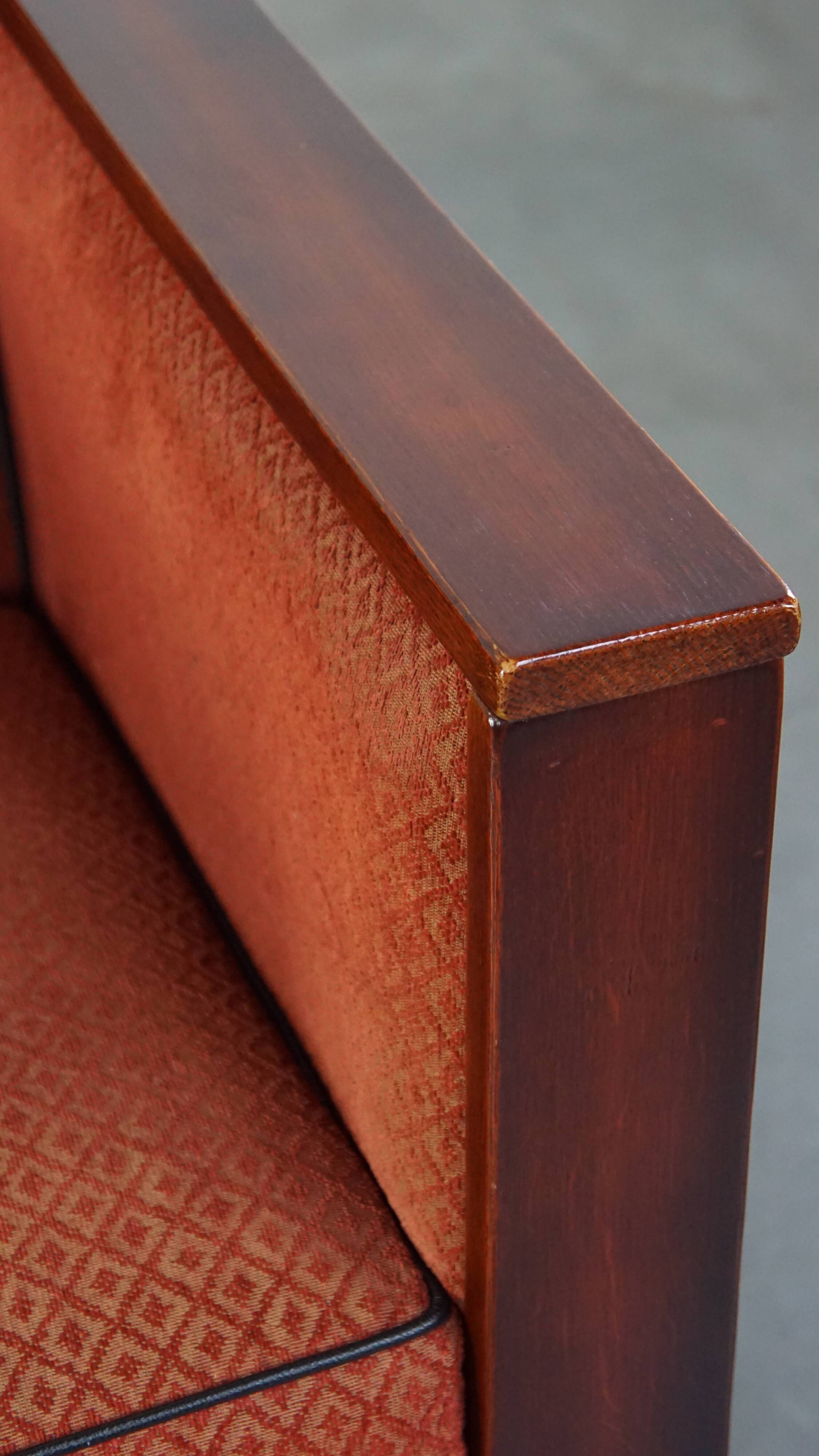 Art Deco design armchair with red fabric upholstery and wooden details