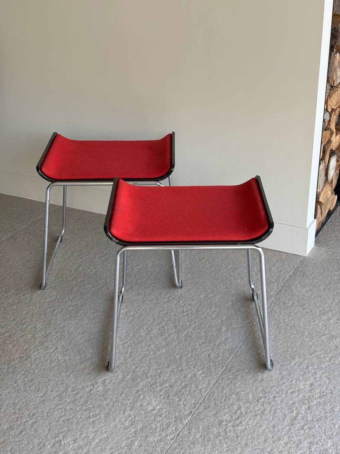 Pair of minimalist stools in red fabric with chrome legs