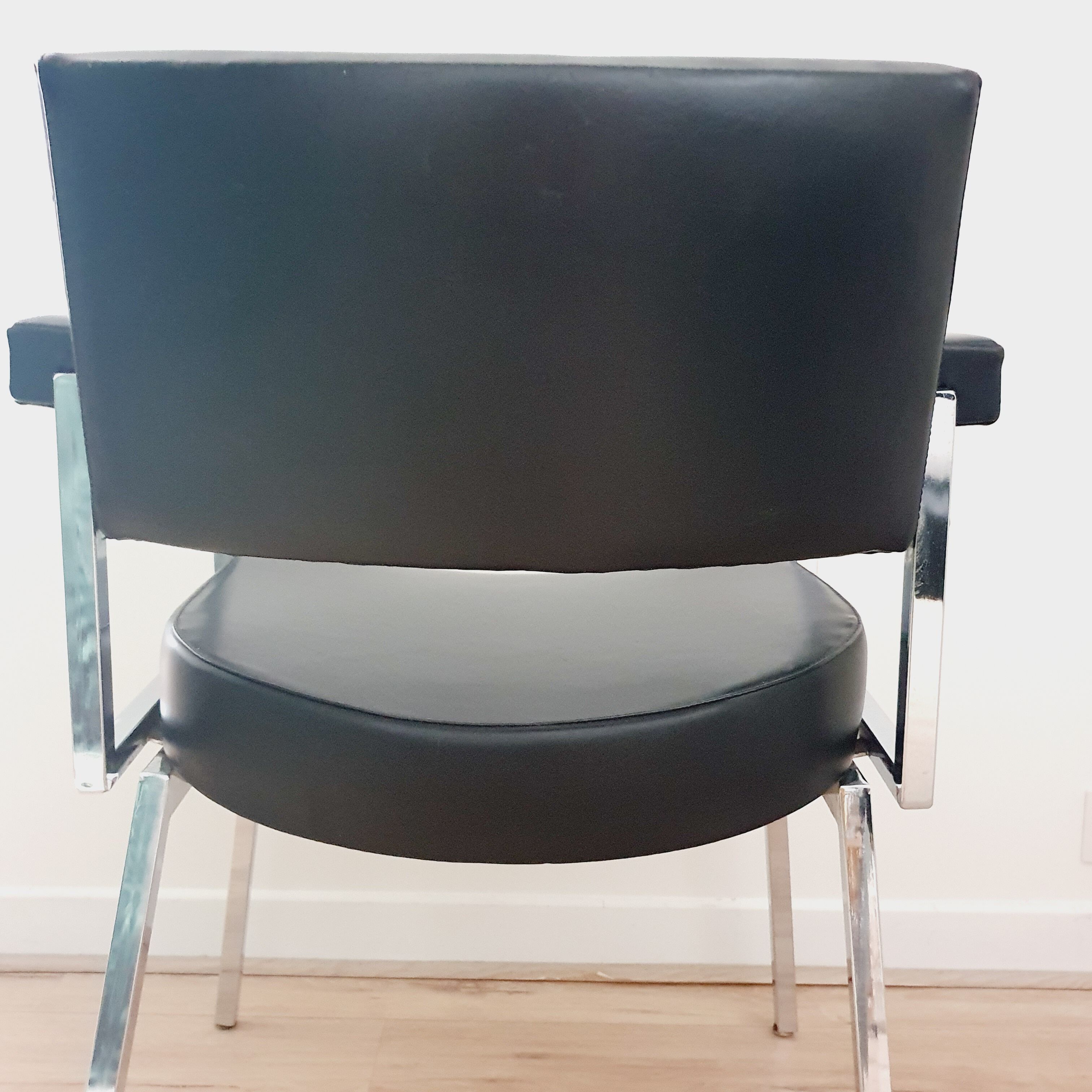 Pair of black skaï and chrome armchairs