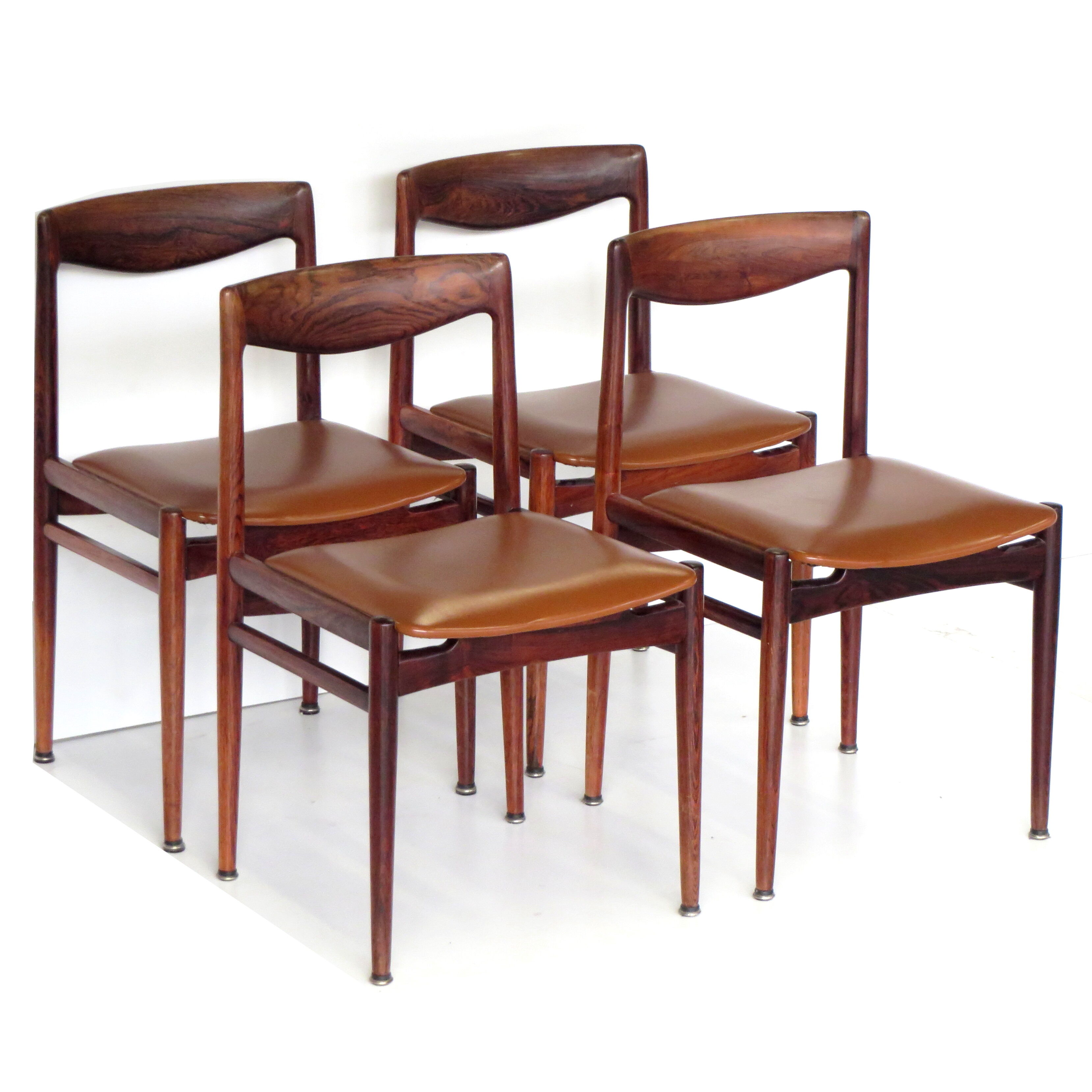Set of four vintage mid century rosewood dining chairs with cognac leather seats