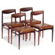 Set of four vintage mid century rosewood dining chairs with cognac leather seats