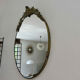 Oval mirror in gilded brass with frieze 40s 50s, 37x50 cm
