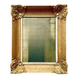 Old wall frame in carved gilded wood