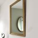 Antique mirror with a gilded frame and beaded border.