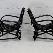 Pair of black lacquered rattan armchairs. France, cira 1960.