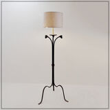 Wrought iron tripod floor lamp decorated with stylized animal heads