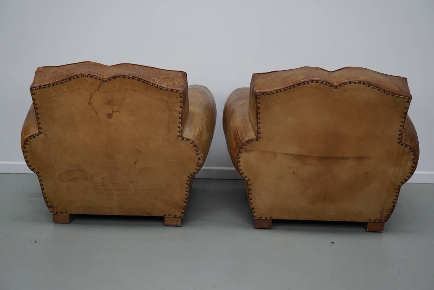 Pair of French club chairs with moustache back in cognac leather, 1940s