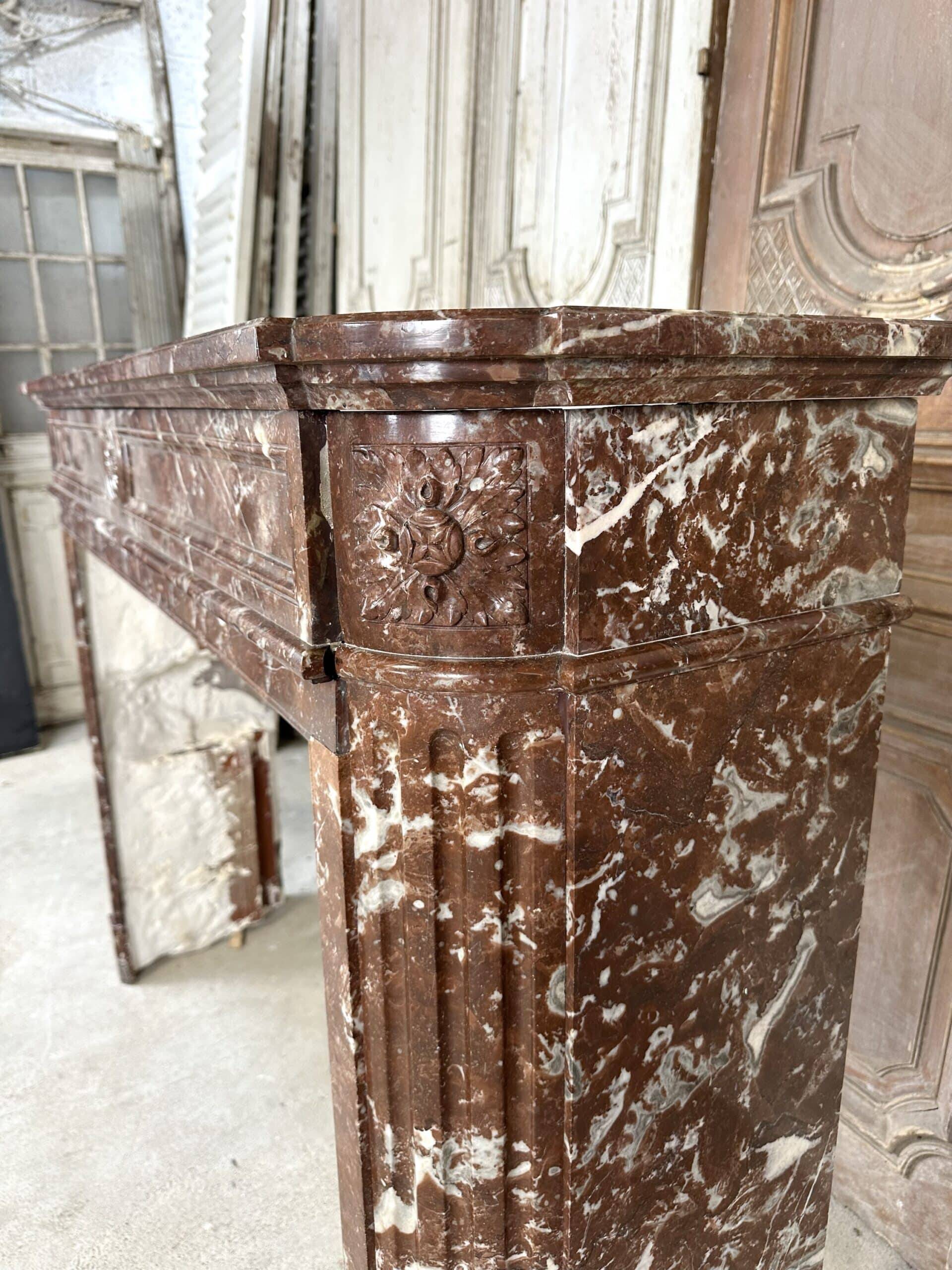 Red marble fireplace in the Louis XVI style, late 19th century